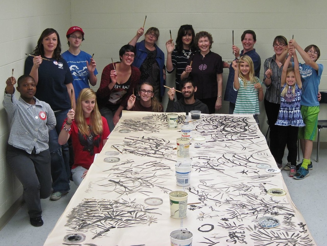 Picture of Blue Ridge Community College students creating a group mural in Chinese brush painting technique