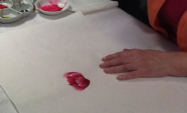Artist paints first ring of red petals