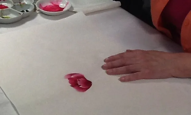 Artist paints first ring of red petals