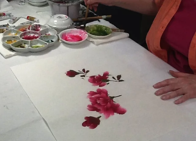 Green calyxes and leaves added to peony flowers