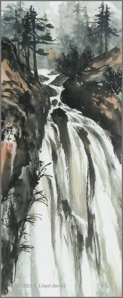 long narrow waterfall with pine trees